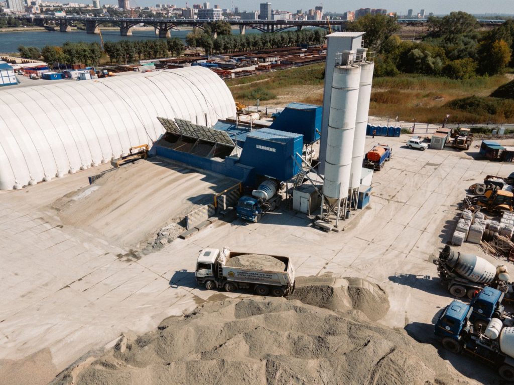 Concrete batching plant with hoppers, silos, and material handling equipment