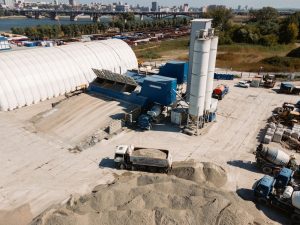 Concrete batching plant with hoppers, silos, and material handling equipment