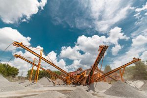 Conveyor belts moving gravel at an aggregate operation under a clear sky