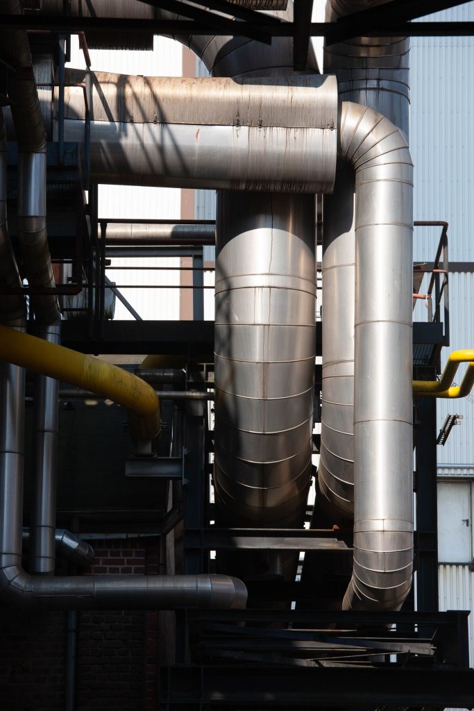 Network of stainless steel pipes and ductwork in an industrial facility