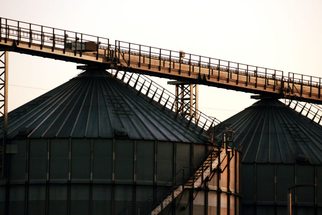Steel storage silos connected by an overhead walkway