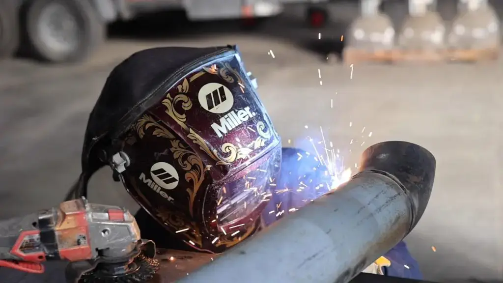 Welder fabricating a discharge pipe for air cannon